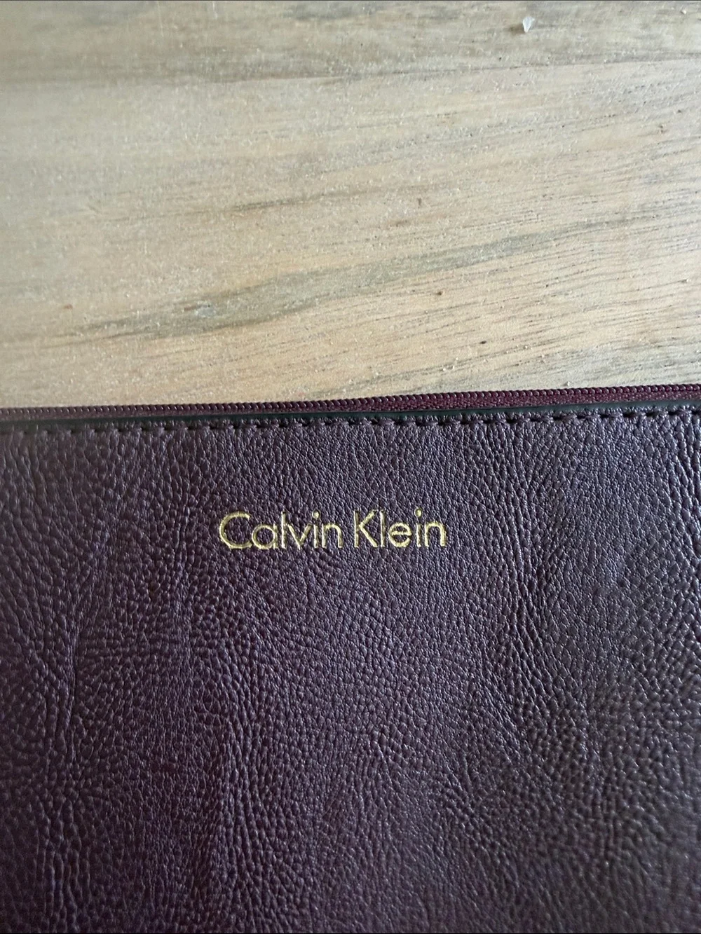 Calvin Klein Dark Brown almost maroon like Leather Wristlet Pouch with Gold Logo